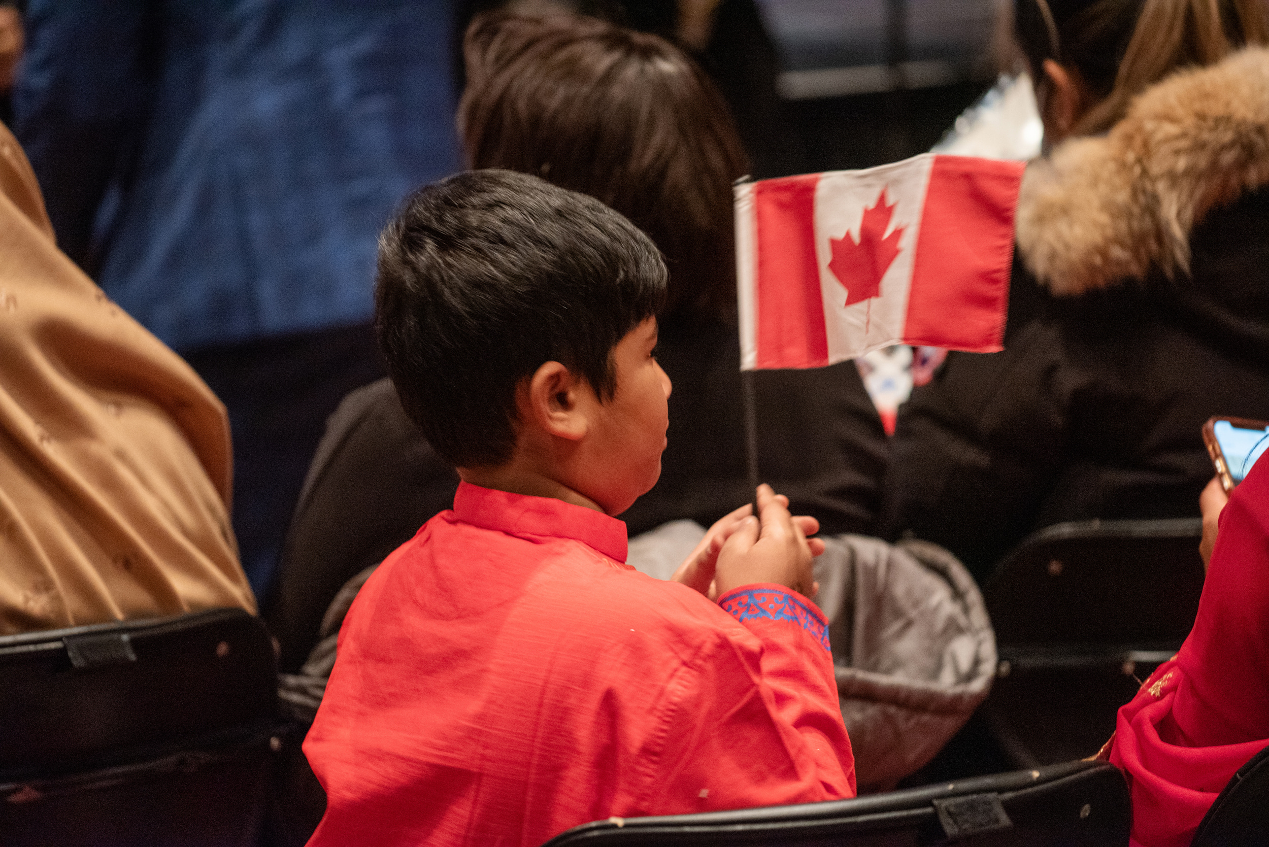 Young child holding a Canadian Flag.