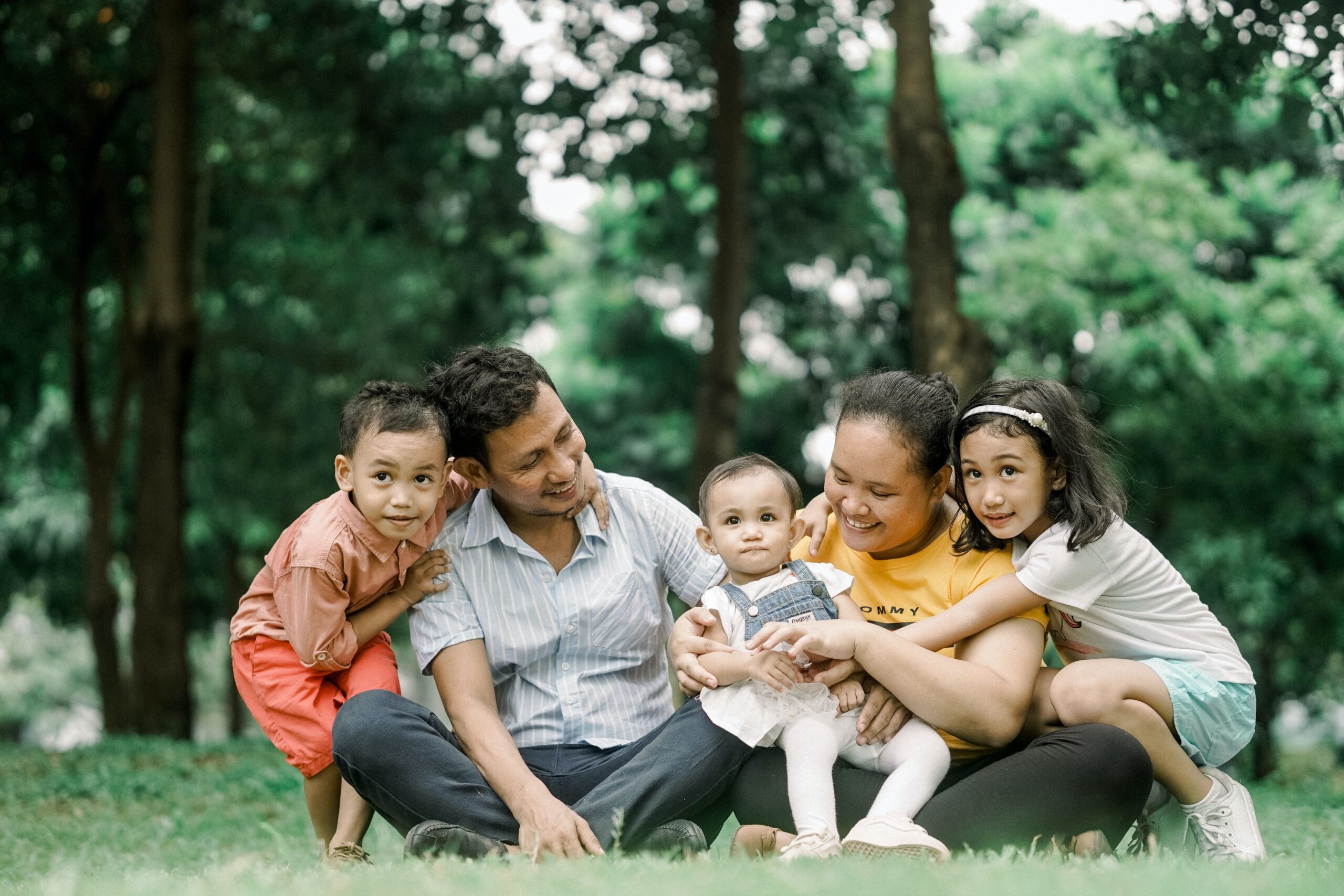 Family of five sits together outside
